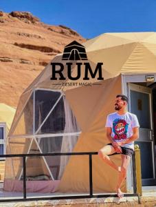 a man sitting in front of a tent at Rum desert magic in Wadi Rum