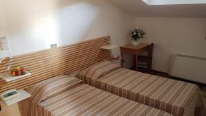 Letto o letti in una camera di Albergo Natucci