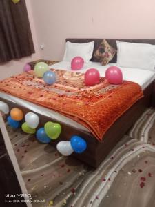 a bed with balloons on top of it at Hotel vikram in Khajurāho