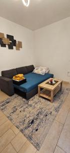 a living room with a blue couch and a coffee table at NICROB in Monfalcone