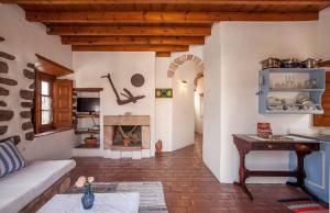 a living room with a couch and a fireplace at Theologos Houses in Grikos