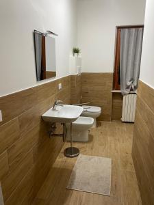 a bathroom with a white sink and a toilet at CASA MAJA casa per vacanze abruzzo in Lettomanoppello