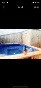 a blue hot tub with a bottle sitting in it at Beautiful cottage with Mountain View in Fludir