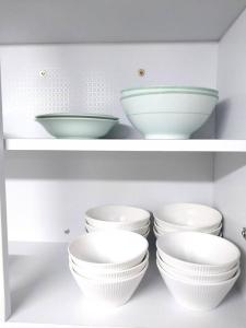 a group of bowls on shelves in a kitchen at Time House - Dongdaemun district in Seoul