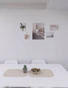 a white table with a bowl of plants on it at Time House - Dongdaemun district in Seoul