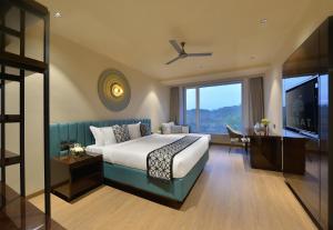una camera d'albergo con letto e TV di URBANE BY TREAT a Daman