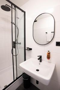 a bathroom with a sink and a mirror at Dream Factory by Hotel Bergheim in Bergheim