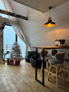 a living room with a table and a christmas tree at SweeDom A-Frame in Besqaynar