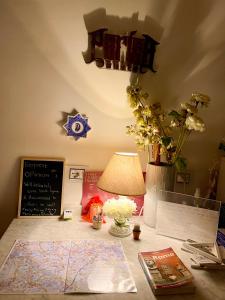 a desk with a lamp and a map on it at parisa suite in Rome