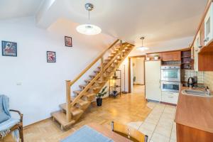 a kitchen with a spiral staircase in a home at Kraków Charm in Krakow