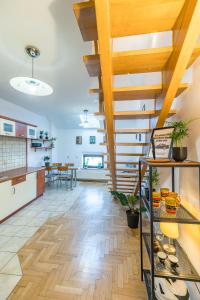 a large kitchen with wooden ceilings and a staircase at Kraków Charm in Krakow
