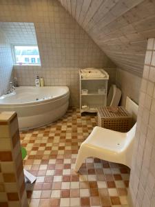 a bathroom with a bath tub and a sink at House built in 1901 close to Eurovision in Limhamn