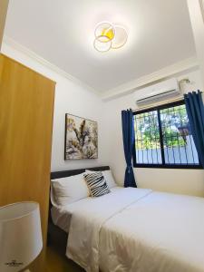 a bedroom with two beds and a window at MP Apartments Leyte in Hindang