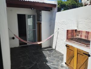 a door to a house with a rope outside at Casa San Clemente del Tuyú in San Clemente del Tuyú