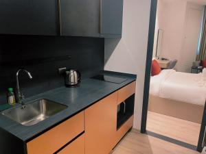 a kitchen with a sink and a bed in a room at EDGE Central Pattaya Super Condo in Pattaya Central +143 photos