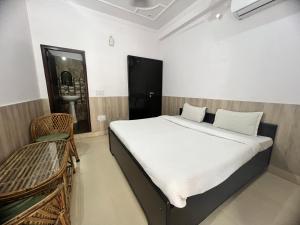 a bedroom with a bed and a chair in it at Tulsi Cottage in Rishīkesh