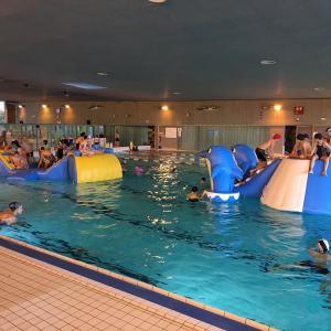 a group of people swimming in a swimming pool at F2 4 pers 2lits proche 5 min aéroport Orly Chez Sandro et Abby in Athis-Mons