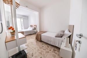 Postel nebo postele na pokoji v ubytování B&B - Le Tre Comari