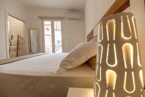 a bedroom with a large white bed in a room at B&B - Le Tre Comari in Ragusa