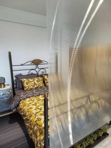 A bed or beds in a room at Polys Apartment and Paraskevi studio with view