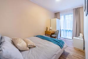 1 dormitorio con 1 cama, escritorio y ventana en Apartament Przy Parku, en Kędzierzyn-Koźle