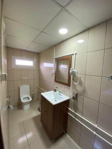 a bathroom with a sink and a toilet at MARİNO HOTEL in Gulyali