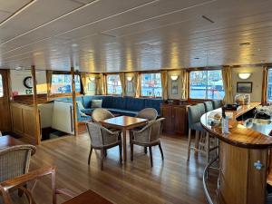 a dining area of a boat with a table and chairs at Hotelboat Angeline in Amsterdam