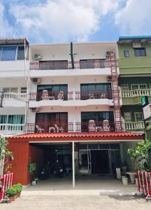 an apartment building with a balcony with chairs on it at Benetti house in Patong Beach