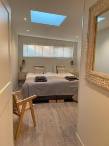 Un dormitorio con una cama grande y una claraboya. en Villa de Duinfazant, en Bergen aan Zee 17 fotos más