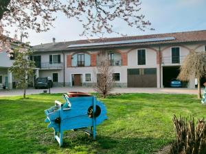 a blue bench in a yard in front of a house at Anticopodere in Casorzo