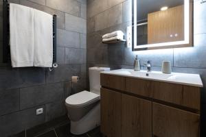 a bathroom with a toilet and a sink at Casinha da Praia - Beachside Retreat Almoxarife in Praia do Almoxarife +17 photos