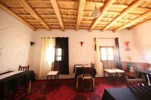 a room with chairs and a table and a ceiling at Riad Villa Dades in Boumalne