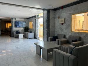 a lobby with couches and a table in a building at فندق بلانتي 2 in Al Madinah