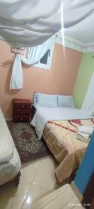 a bedroom with a bed and a window at Casa Lotfi in Chefchaouene