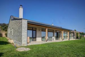 una casa de piedra con chimenea en el césped en Eco complex Zdravets, en Zdravets