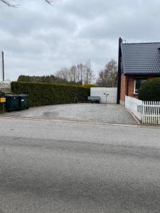 an empty parking lot next to a house at Svedala Malmö villa 7 bäddar in Svedala