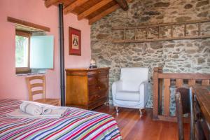 a bedroom with a bed and a stone wall at Casa San Martino Lago Di Como in San Siro