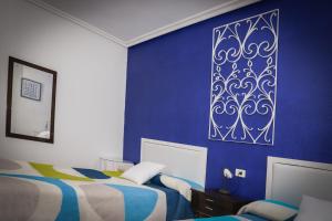 A bed or beds in a room at Casa los Arcos