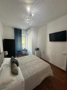 a bedroom with a bed and a flat screen tv at Room Sapienza in Rome