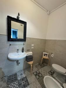 a bathroom with a sink and a toilet and a mirror at Room Sapienza in Rome