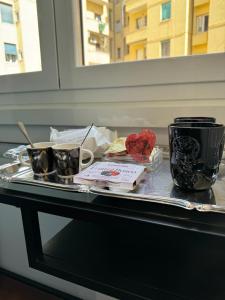 a tray with two cups and two cups on a table at Room Sapienza in Rome