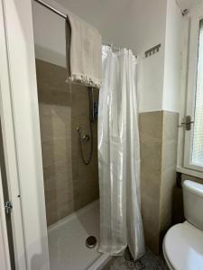 a bathroom with a shower with a shower curtain at Room Sapienza in Rome