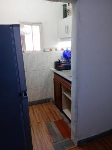 a kitchen with a door open to a kitchen with a counter at Sofia in Montevideo