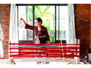 a woman standing next to a red bench at Gongwi Cottages Sidemen in Sidemen
