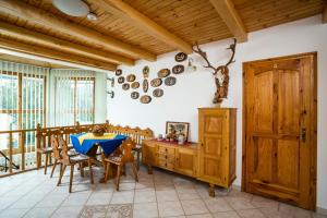 a dining room with a table and some pots and pans at Villa Jäger in Vonyarcvashegy