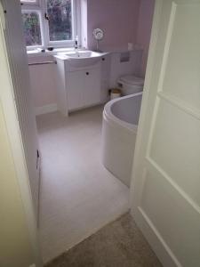 A bathroom at Cotswolds cottage near Stroud, with amazing views.