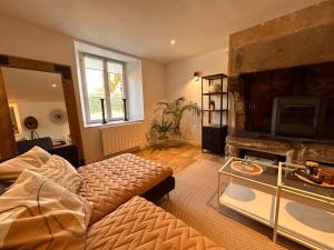 a living room with a couch and a fireplace at Le Ker Maclow in Saint Malo