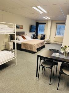 a large room with a bed and a desk and chairs at Route 154, 15 min till Ullared in Älvsered