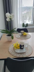 a wooden table with two cups and a plate of food on it at Studio 12 floor, Puijo landscape, Free parking in Kuopio +18 photos