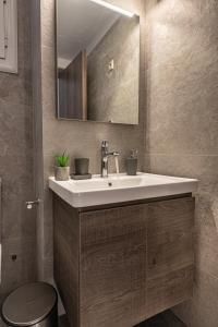 a bathroom with a sink and a mirror at Loutraki Hidden Gem IV in Loutraki